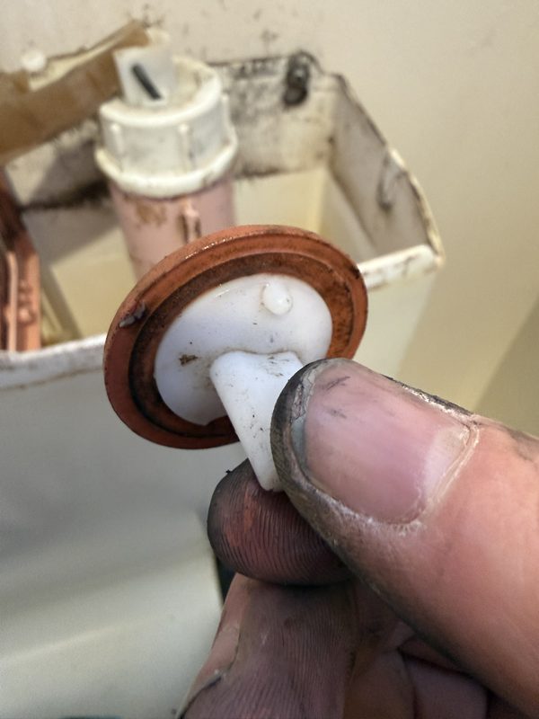 Worn washer from a leaking Aspro toilet cistern inlet valve in St Martins