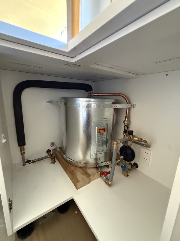 Medium pressure hot water cylinder installed under a bench in a Halswell home