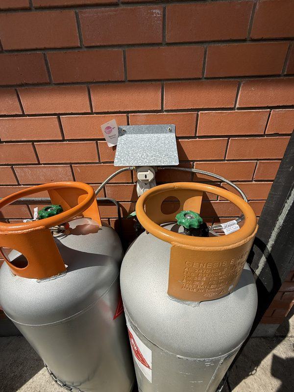 New LPG pigtail hoses connecting two 45kg gas bottles to a changeover regulator on a Cashmere home