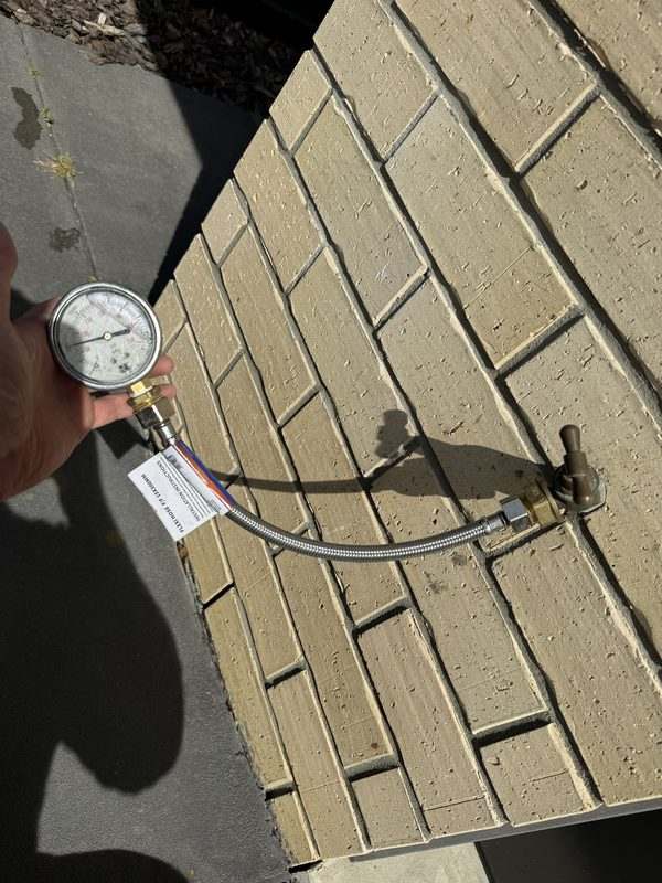 Pressure gauge on an outside tap, checking the mains water pressure at a Rolleston property